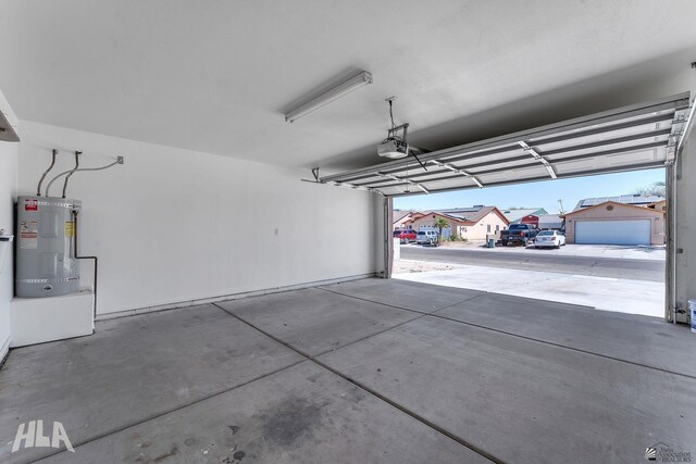 garage with electric water heater and a garage door opener