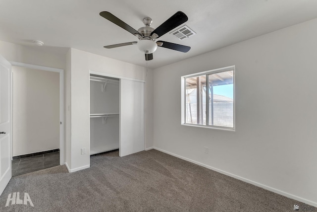 unfurnished bedroom with baseboards, a closet, carpet floors, and visible vents