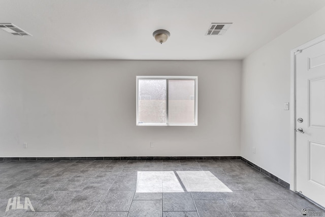 empty room with visible vents and baseboards