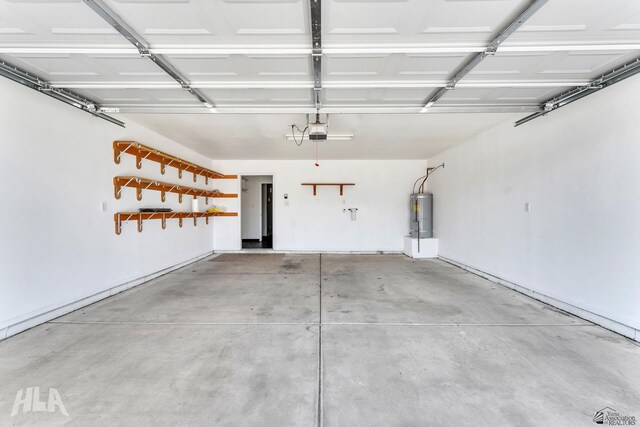 garage with electric water heater and a garage door opener