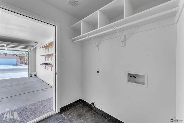 laundry area featuring visible vents, laundry area, electric dryer hookup, washer hookup, and a garage