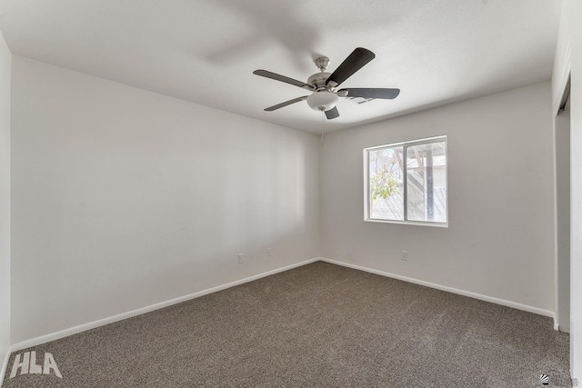 unfurnished bedroom with dark carpet, a ceiling fan, and baseboards