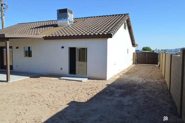 13112 E 54th St, Yuma, AZ 85367 - back of house with stucco siding, a tile roof, a patio, and a gate