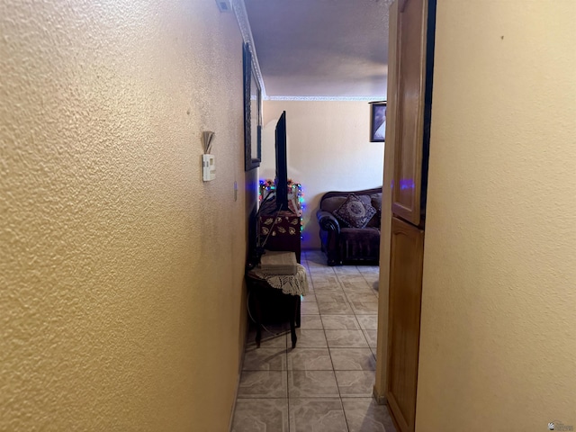 219 E Rio Sonora St, San Luis, AZ 85336 - hallway with light tile patterned flooring, a textured wall, and ornamental molding