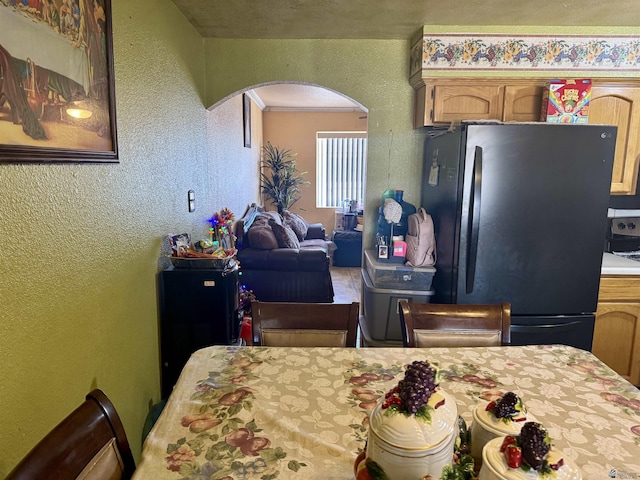 219 E Rio Sonora St, San Luis, AZ 85336 - dining space featuring arched walkways and a textured wall