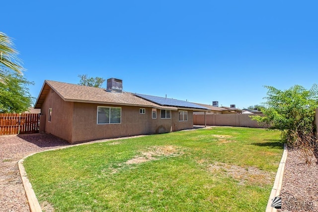 11279 E 26th Ln, Yuma, AZ 85367 - back of property with roof mounted solar panels, a fenced backyard, and stucco siding