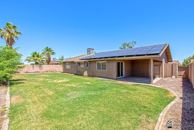 11279 E 26th Ln, Yuma, AZ 85367 - back of property featuring a patio area, a fenced backyard, solar panels, and stucco siding