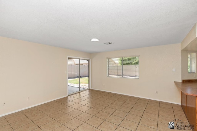 11279 E 26th Ln, Yuma, AZ 85367 - empty room featuring light tile patterned floors, a textured ceiling, and recessed lighting