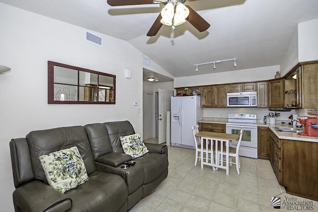 13405 E 54th St, Yuma, AZ 85367 - living room featuring light tile patterned floors, ceiling fan, vaulted ceiling, and visible vents
