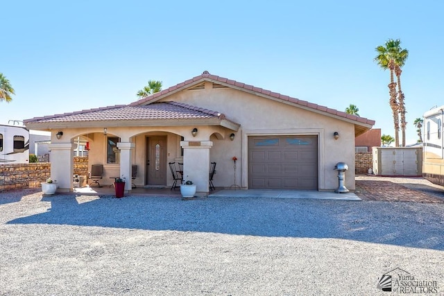 13405 E 54th St, Yuma, AZ 85367 - view of front facade with a garage, stucco siding, a tiled roof, and gravel driveway