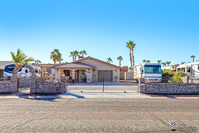 13405 E 54th St, Yuma, AZ 85367 - view of front of house featuring concrete driveway, a gate, a fenced front yard, and an attached garage