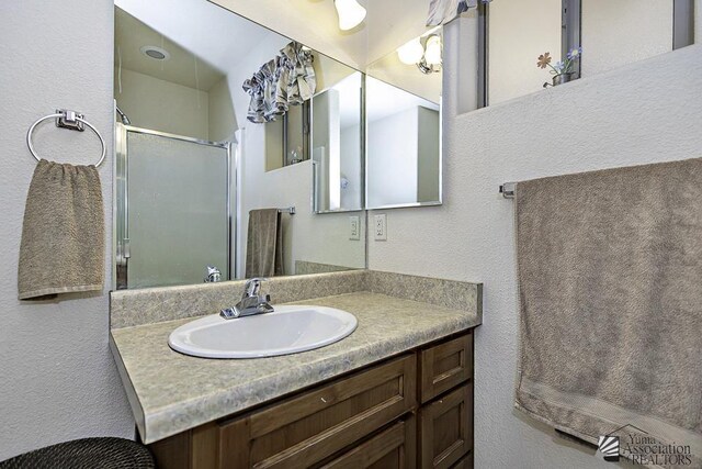 13405 E 54th St, Yuma, AZ 85367 - full bathroom with vanity, a textured wall, and a stall shower
