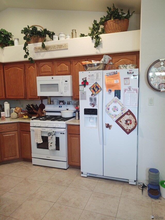 13375 E 52nd St, Yuma, AZ 85367 - kitchen featuring white appliances, brown cabinetry, light countertops, and light tile patterned floors
