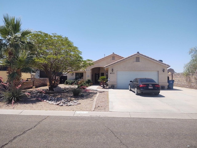 13375 E 52nd St, Yuma, AZ 85367 - view of front of property with a garage, stucco siding, concrete driveway, and fence