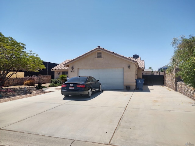 13375 E 52nd St, Yuma, AZ 85367 - view of front of property featuring stucco siding, concrete driveway, an attached garage, fence, and a tiled roof