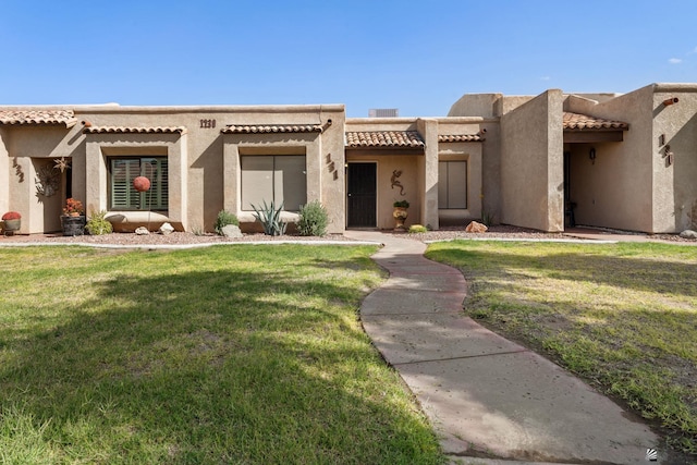 11230 E 37th Pl Unit 131, Yuma, AZ 85367 - adobe home with a front yard, a tile roof, and stucco siding