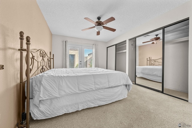 11230 E 37th Pl Unit 131, Yuma, AZ 85367 - carpeted bedroom with two closets, a textured ceiling, access to outside, a ceiling fan, and french doors