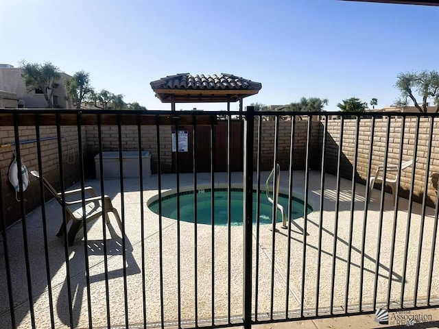 11230 E 37th Pl Unit 131, Yuma, AZ 85367 - gate featuring a patio area and a swimming pool