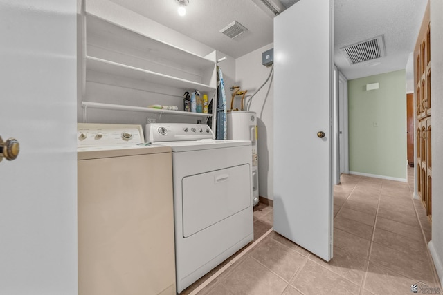 11230 E 37th Pl Unit 131, Yuma, AZ 85367 - washroom with separate washer and dryer, water heater, and light tile patterned flooring