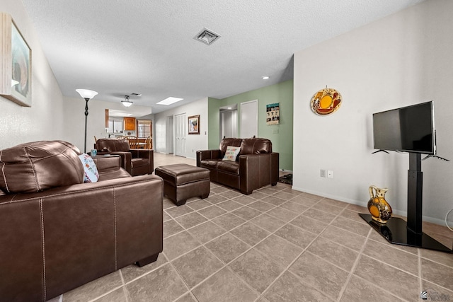 11230 E 37th Pl Unit 131, Yuma, AZ 85367 - tiled living area featuring a textured ceiling