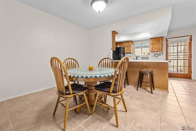 11230 E 37th Pl Unit 131, Yuma, AZ 85367 - dining area featuring light tile patterned floors and a textured ceiling