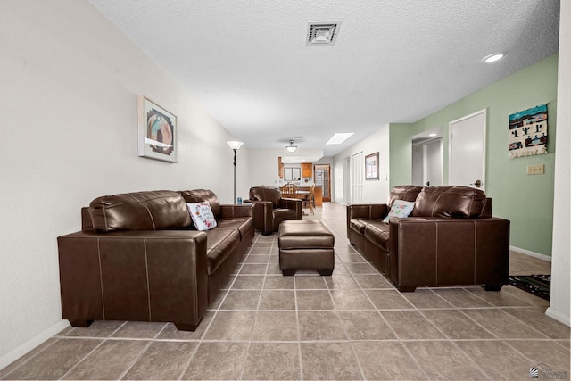 11230 E 37th Pl Unit 131, Yuma, AZ 85367 - living room with a textured ceiling and baseboards