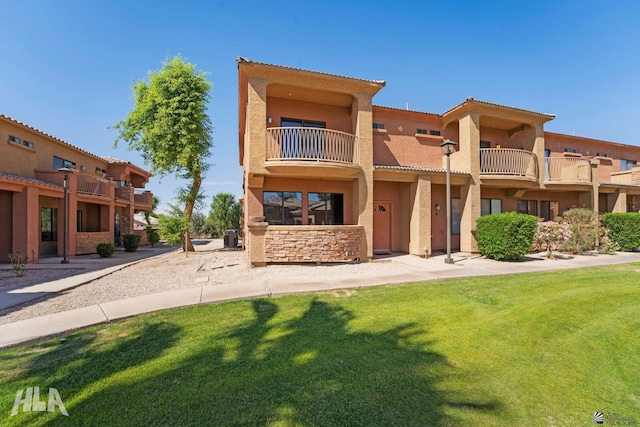3591 W 22 Street 3591W 22Nd Street, #E, Yuma, AZ 85364 - view of front of property with a front lawn, stucco siding, a balcony, and a tile roof