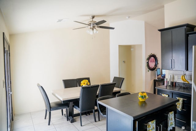 dining room featuring baseboards, a ceiling fan, and light tile patterned floors