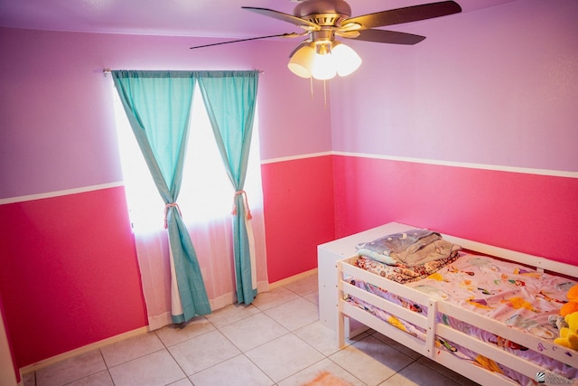 bedroom with baseboards, ceiling fan, and light tile patterned floors