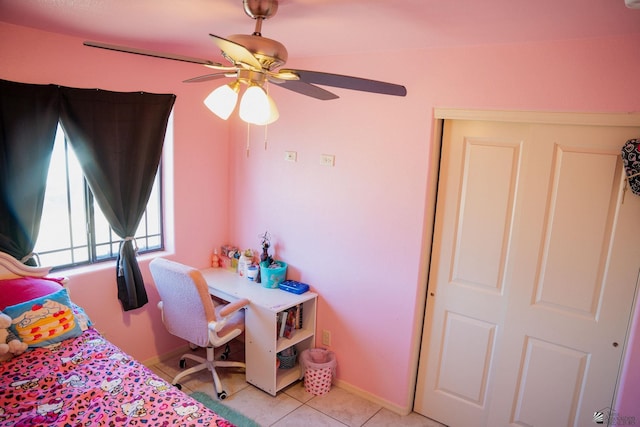 bedroom featuring a ceiling fan, baseboards, and light tile patterned floors