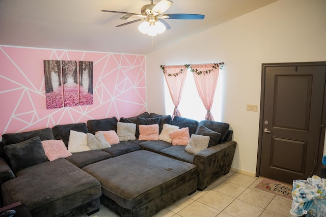 living room featuring a ceiling fan, vaulted ceiling, and light tile patterned floors