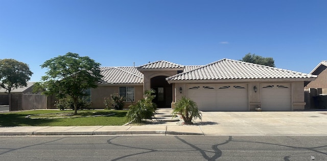 3769 W 25th Ln, Yuma, AZ 85364 - view of front of house with an attached garage, stucco siding, a tiled roof, and driveway