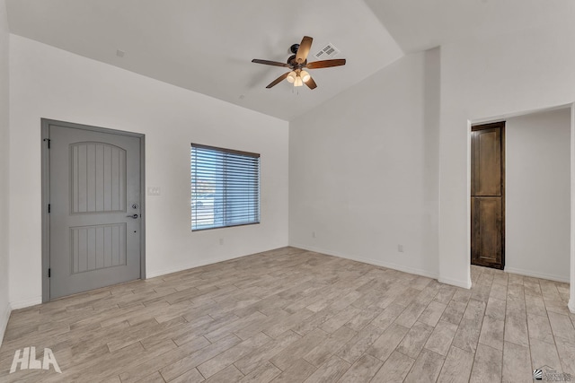 interior space featuring light wood-type flooring, ceiling fan, visible vents, and vaulted ceiling