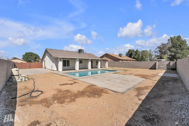 view of swimming pool featuring a patio, a fenced backyard, a fenced in pool, and central air condition unit