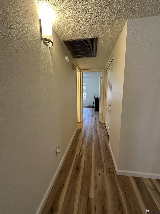 2240 S Elks Ln # 21, Yuma, AZ 85364 - hallway with wood finished floors, baseboards, and a textured ceiling