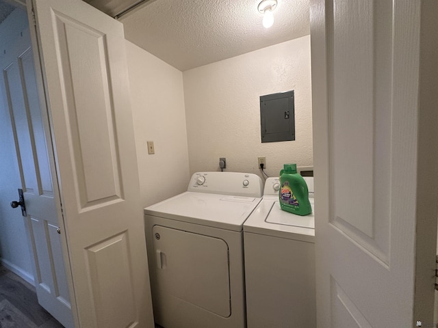 2240 S Elks Ln # 21, Yuma, AZ 85364 - washroom with washing machine and dryer, electric panel, a textured ceiling, and dark wood finished floors