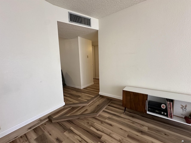 2240 S Elks Ln # 21, Yuma, AZ 85364 - spare room featuring wood finished floors, a textured ceiling, and baseboards