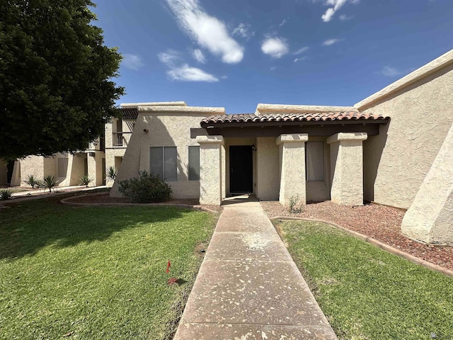 2240 S Elks Ln # 21, Yuma, AZ 85364 - view of front of home featuring stucco siding, a front yard, and a tile roof