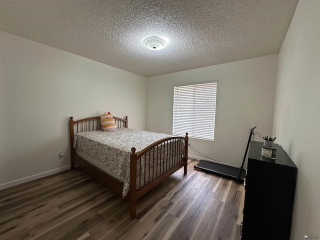 2240 S Elks Ln # 21, Yuma, AZ 85364 - bedroom with wood finished floors, a textured ceiling, and baseboards