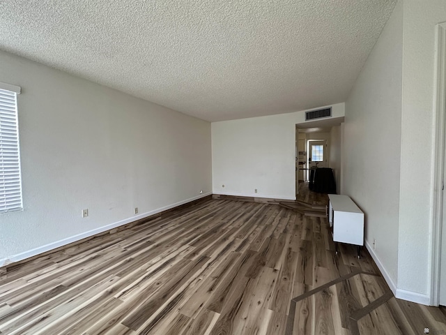 2240 S Elks Ln # 21, Yuma, AZ 85364 - unfurnished living room with a textured ceiling, wood finished floors, and baseboards