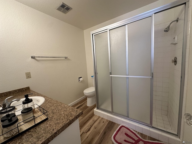 2240 S Elks Ln # 21, Yuma, AZ 85364 - bathroom with wood finished floors, vanity, a shower stall, and toilet