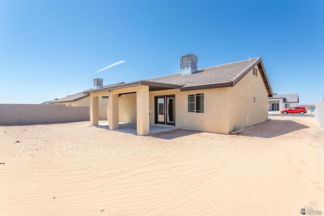 10849 E 45th Pl, Yuma, AZ 85367 - back of house featuring stucco siding, a patio area, a chimney, and a tiled roof
