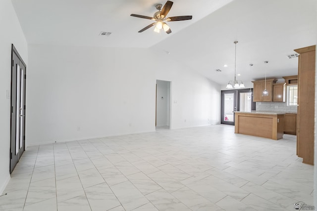 10849 E 45th Pl, Yuma, AZ 85367 - unfurnished living room with ceiling fan, vaulted ceiling, and a chandelier