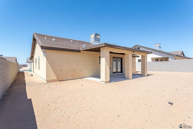 10849 E 45th Pl, Yuma, AZ 85367 - rear view of property featuring stucco siding, a patio area, and a chimney