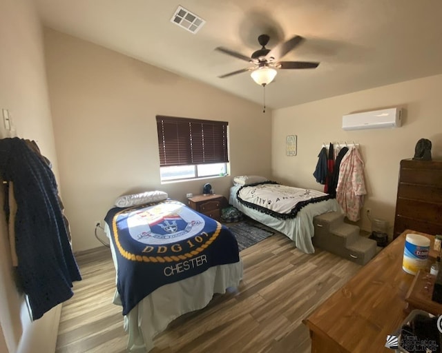3651 E Hernandez St, San Luis, AZ 85336 - bedroom with wood finished floors, a wall mounted AC, vaulted ceiling, and a ceiling fan