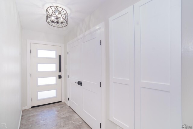 1790 S Meadowbrook Ave, Yuma, AZ 85364 - doorway featuring baseboards, a notable chandelier, and light wood finished floors