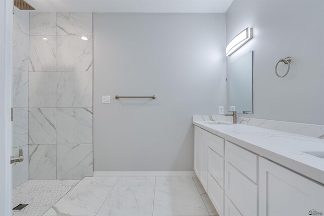 3539 S Akers Way, Yuma, AZ 85365 - bathroom with double vanity, marble finish floor, baseboards, tiled shower, and a sink