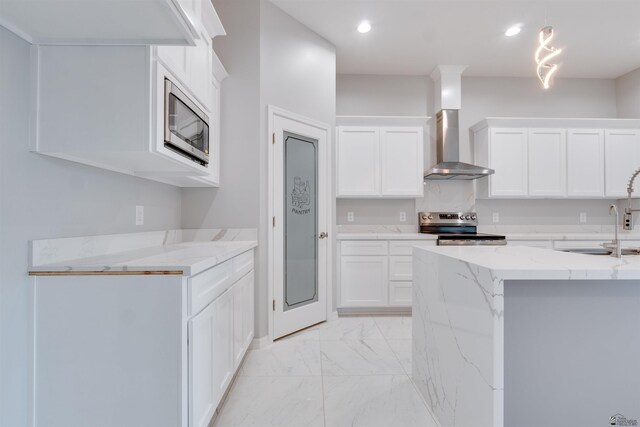 3539 S Akers Way, Yuma, AZ 85365 - kitchen featuring wall chimney exhaust hood, light stone counters, marble finish floor, stainless steel appliances, and white cabinetry