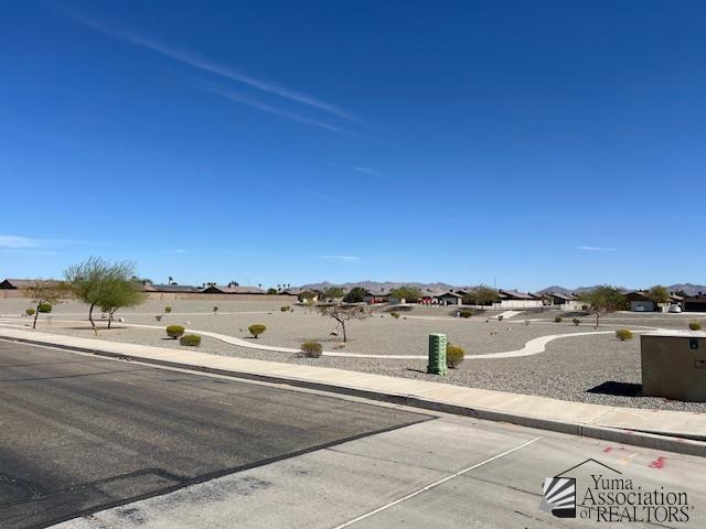 view of road with curbs and sidewalks