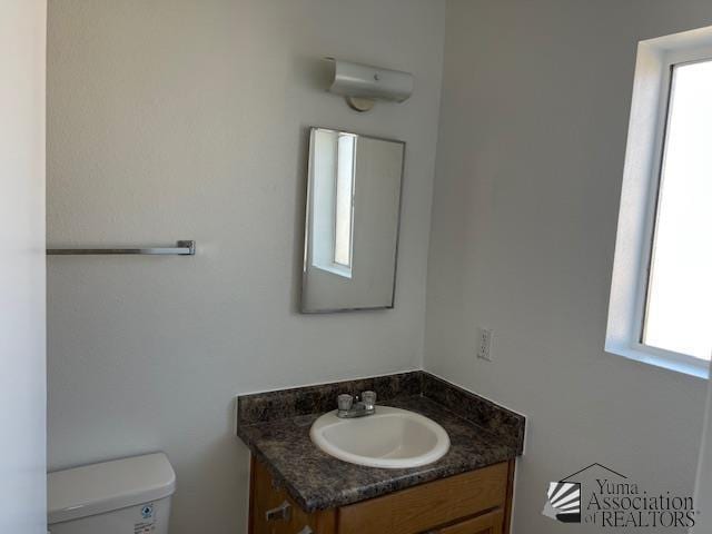 bathroom featuring toilet and vanity